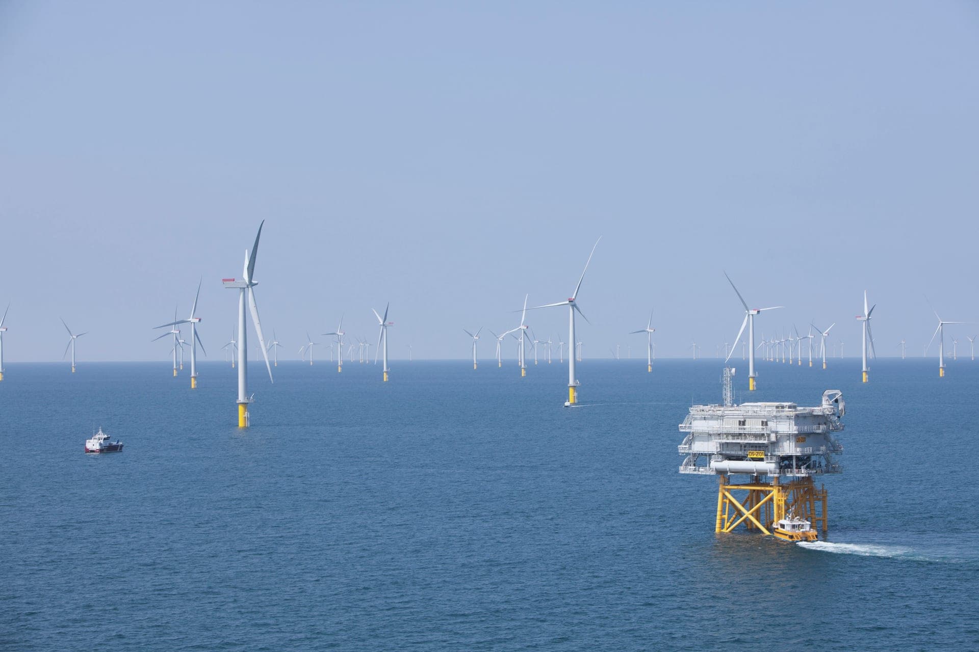 Offshore substation among wind turbines at sea