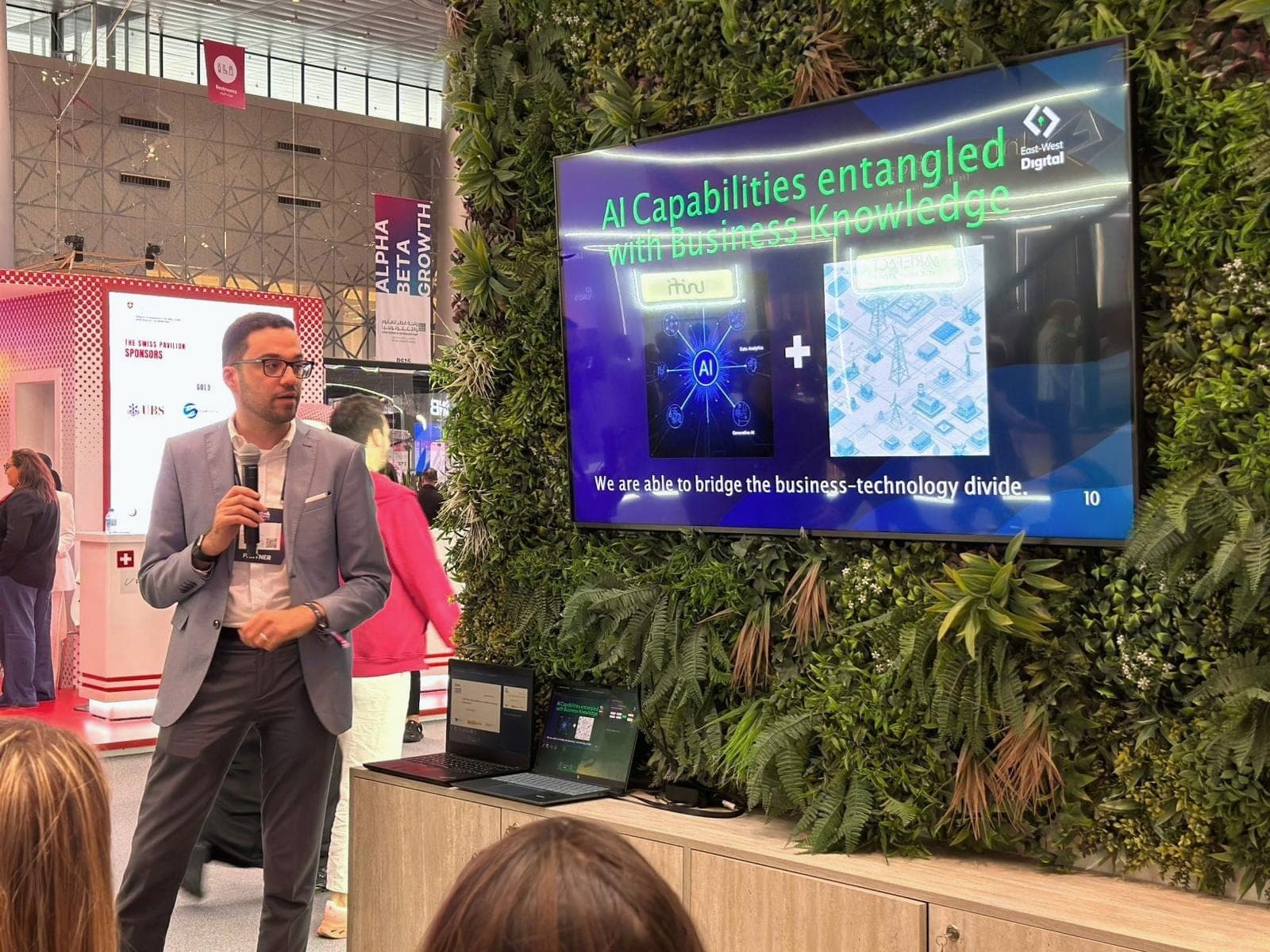 Yazan presenting on AI capabilities to an audience at the EWD stand